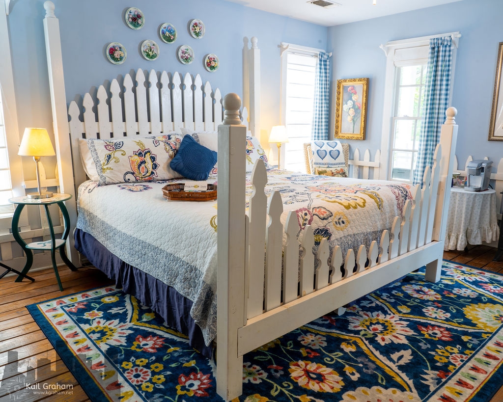 Picket fence king-sized bed frame and garden flowered bedspread