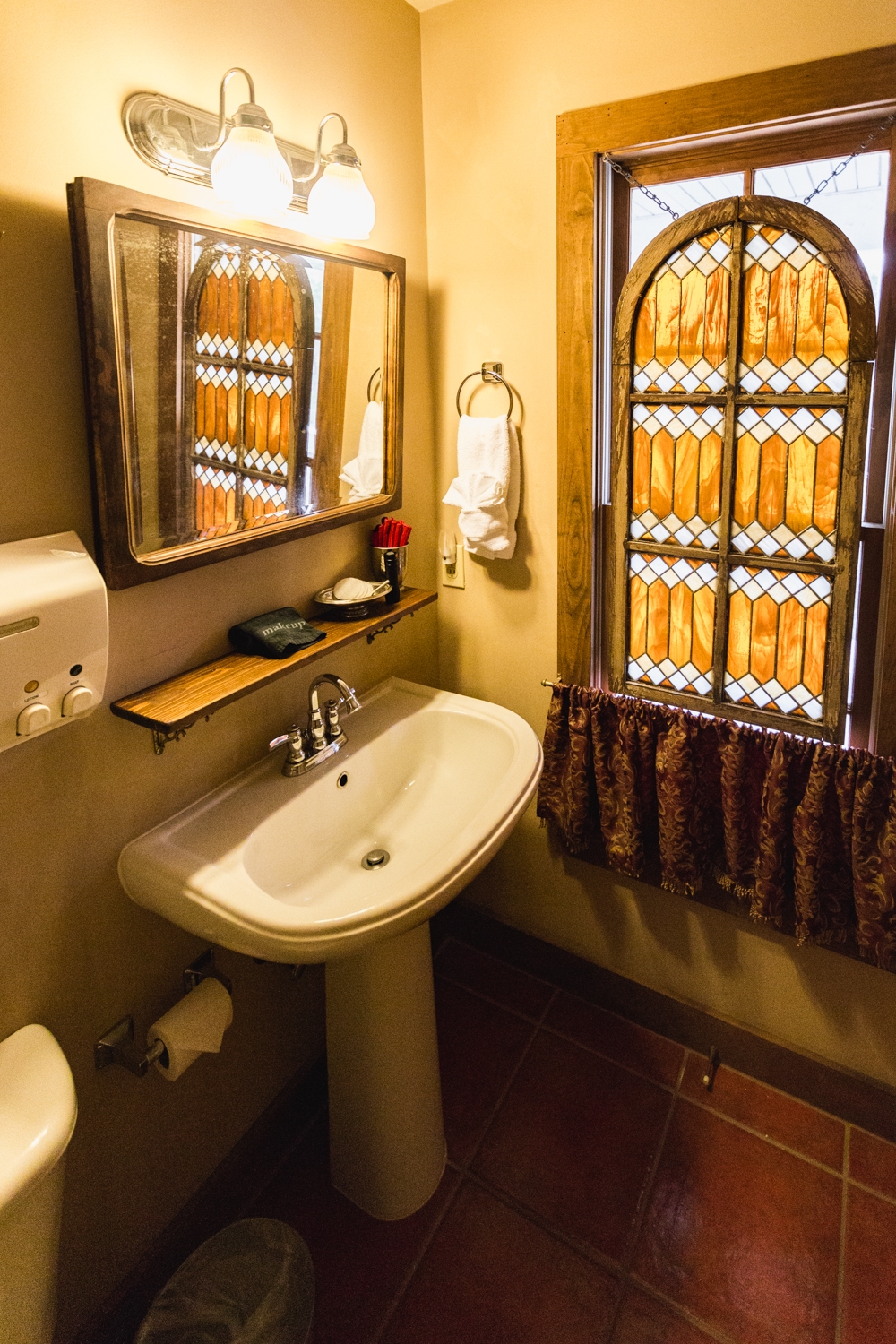 Pedestal sink with stain glass window