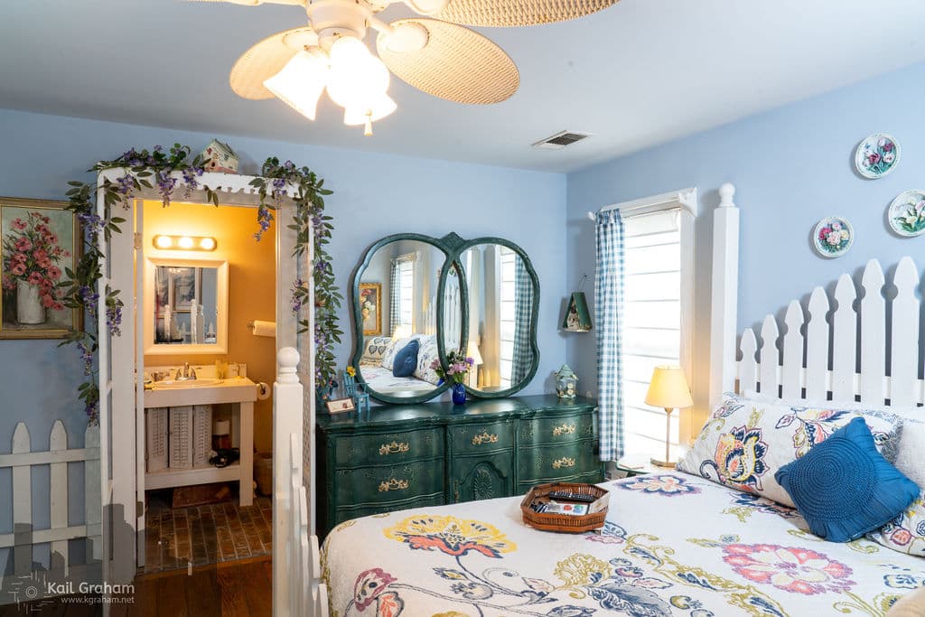 Spring like decor on king-sized bed with dresser and private bathroom