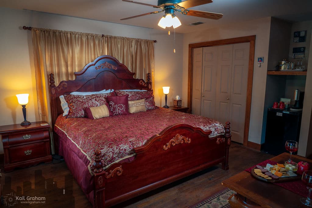 View showing king sized bed, full sized closet and mini refrigerator and coffee maker