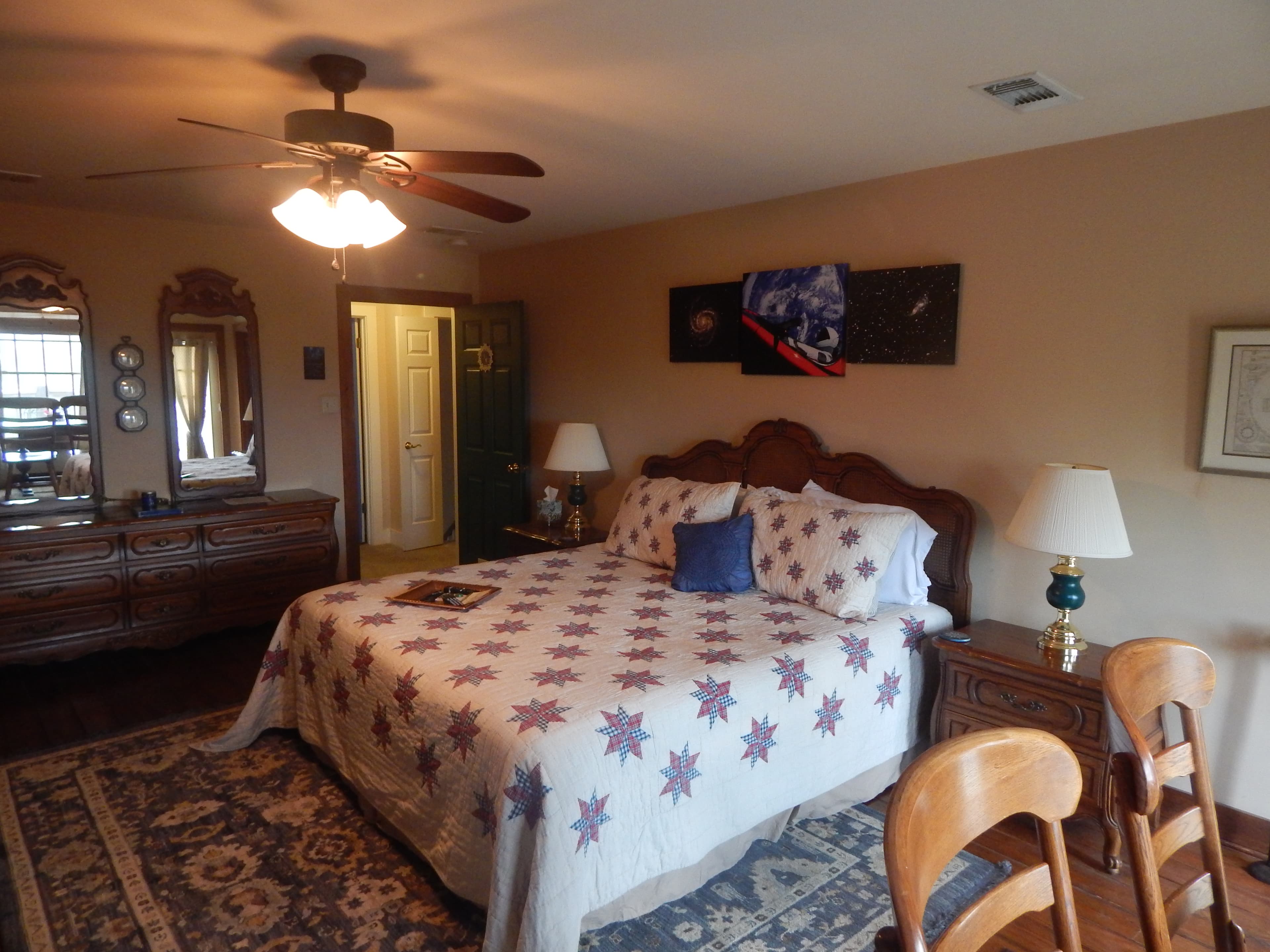 View of bed, dresser and hallway door